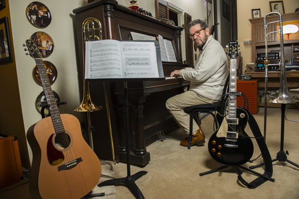 Photo of Norman in his music room