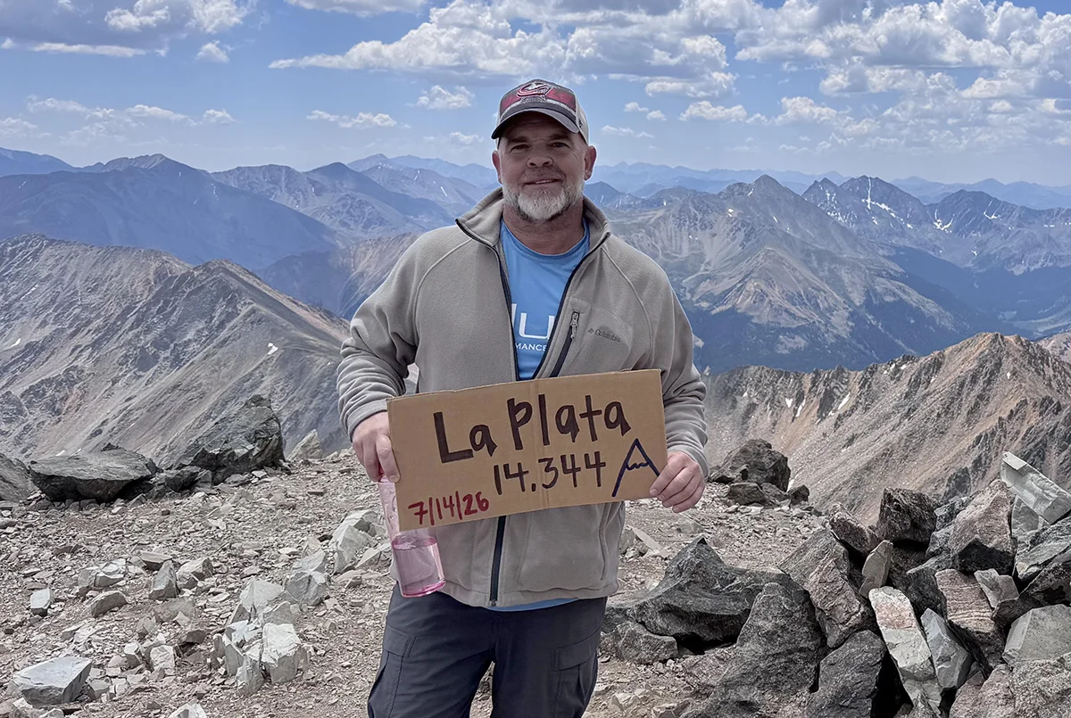 Photo of Jeff standing on the mountain top