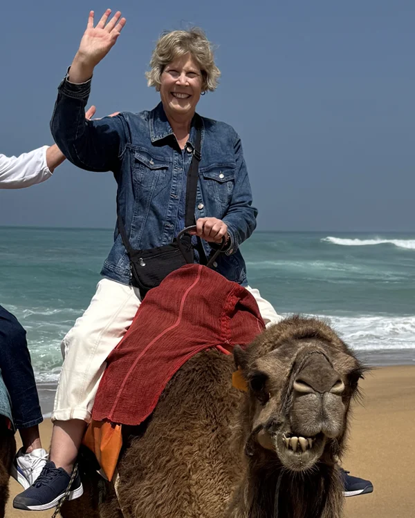 Linda on the beach with a camel